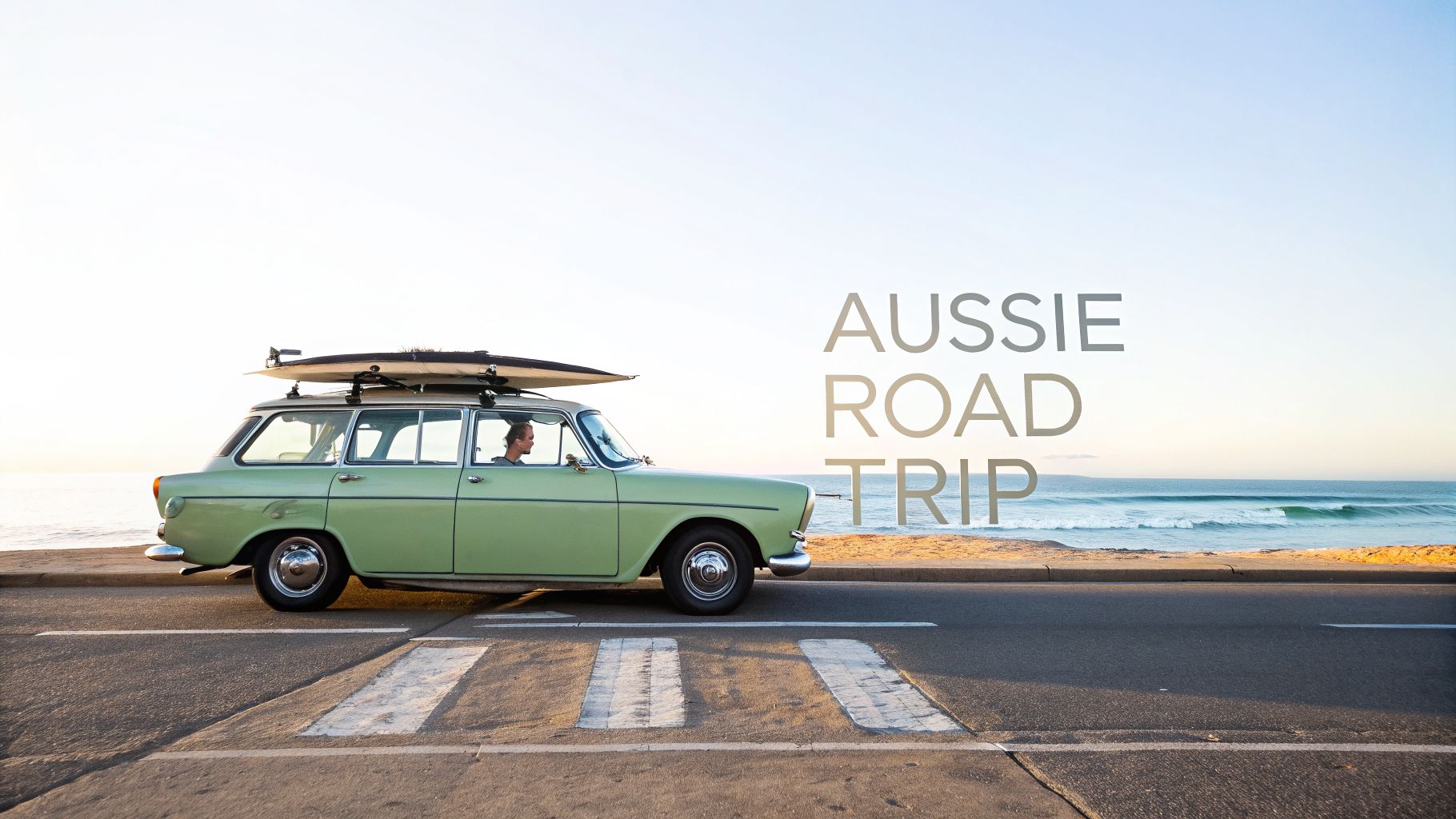 Vintage green station wagon with surfboard on roof by the ocean, with 'AUSSIE ROAD TRIP' text.