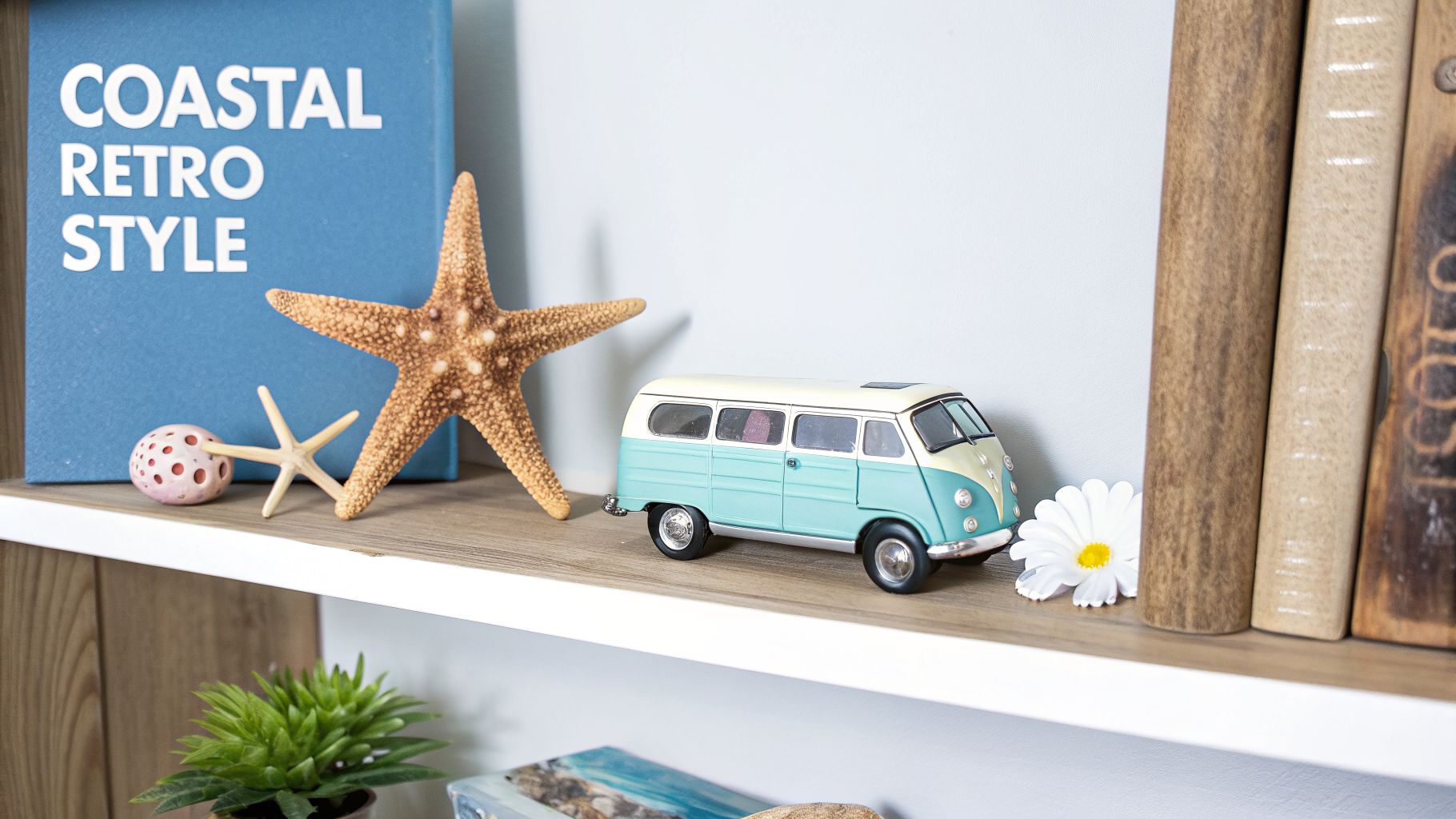 A shelf styled with coastal and retro decor, including a blue book, starfish, a toy van, and old books.