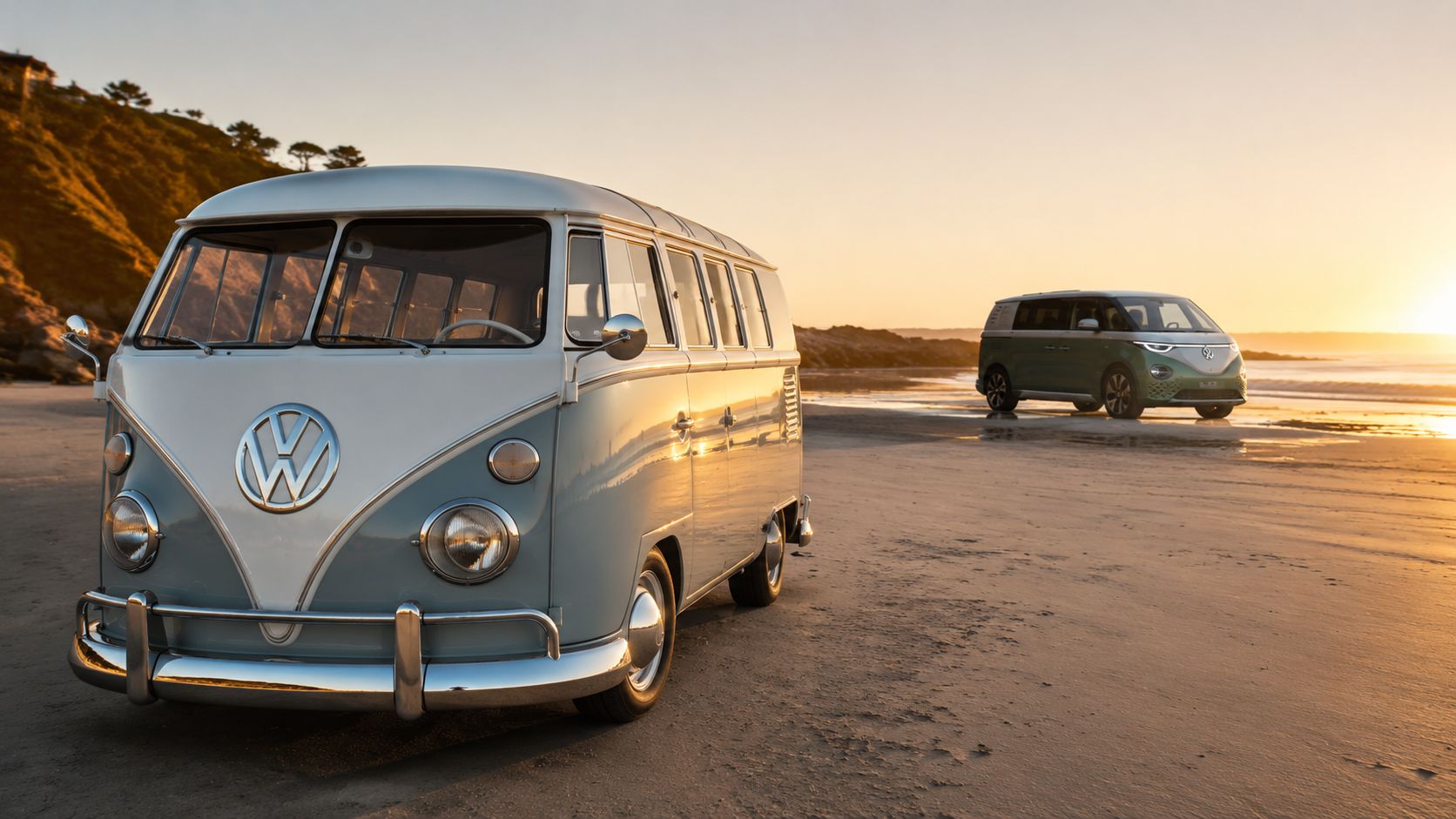 A vintage light blue Volkswagen bus parked on a beach with a modern green ID Buzz behind it.