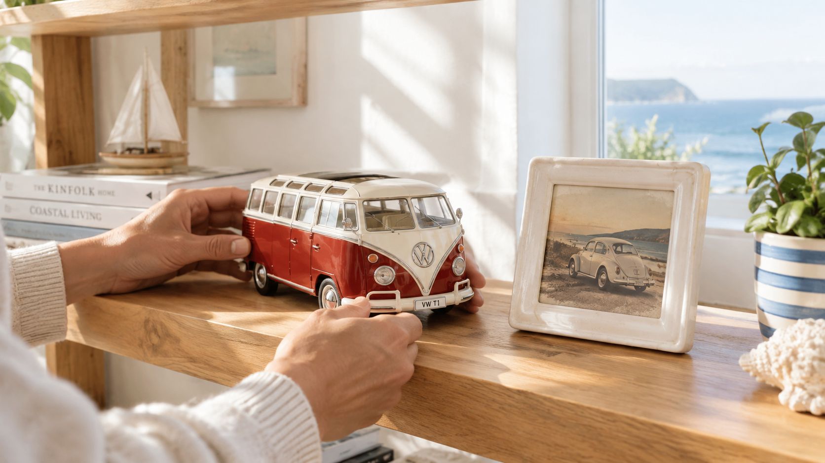 A person placing a red and white Volkswagen T1 toy bus model on a rustic wooden shelf.