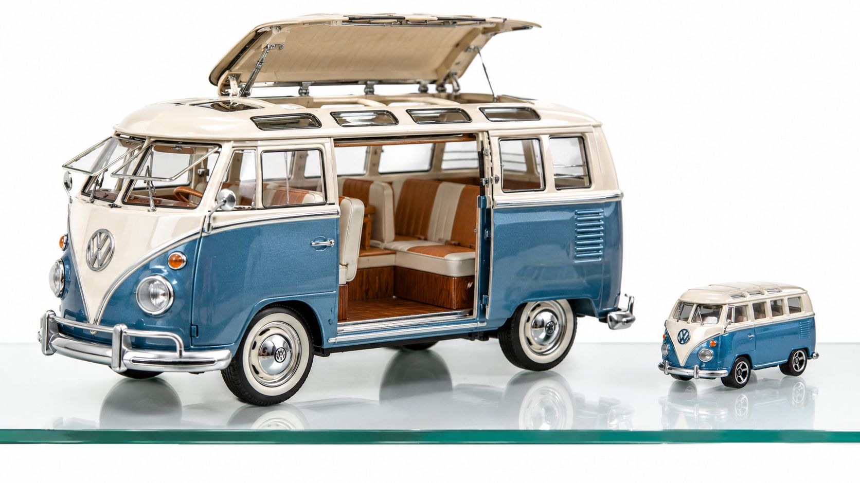 A detailed large scale diecast Volkswagen camper van model displayed next to a smaller miniature version.