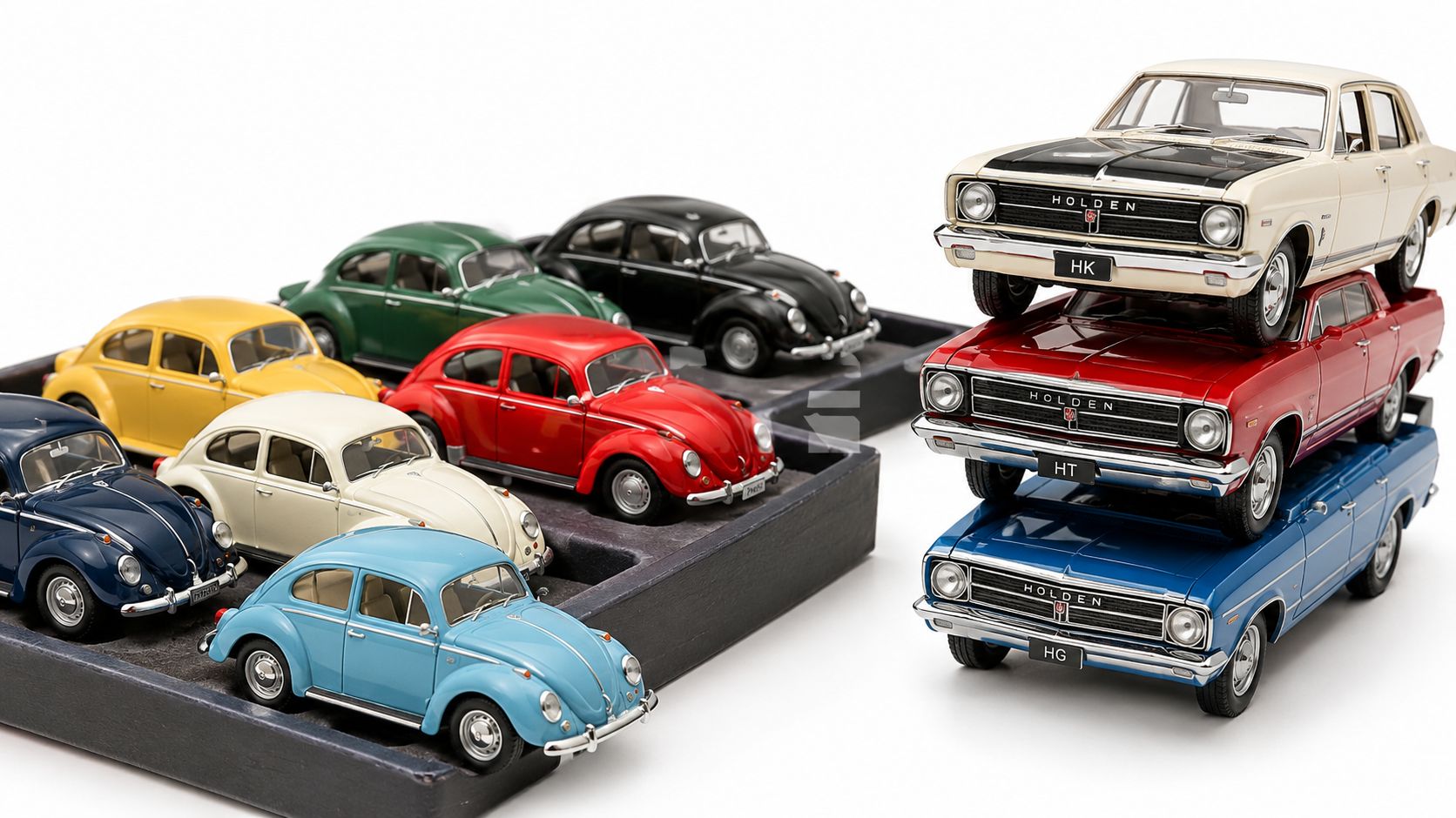 A collection of diecast model cars, including multiple Volkswagen Beetles and a stack of three classic Holden sedans.